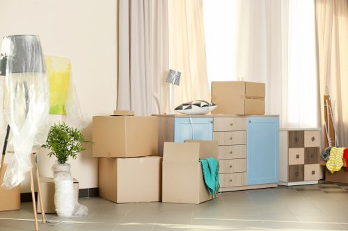 Student removals in Hammersmith with moving boxes and a van on a London street
