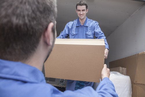 Removal team preparing furniture with safety measures in place
