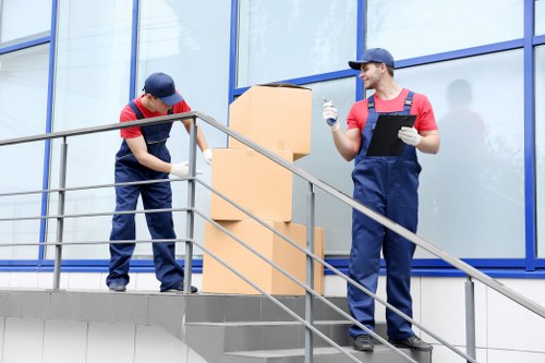 Professional movers handling furniture during a flat removal in Hammersmith