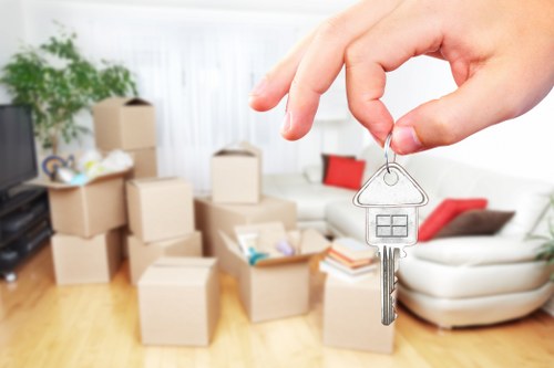 Local movers carrying boxes for a flat move in Hammersmith